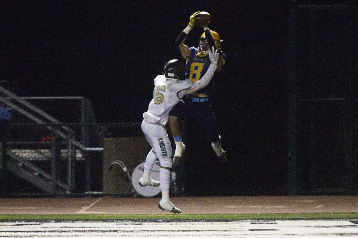 Marina's Dane Brenton catches a 13-yard touchdown against Ontario Christian's Alvis Nuno in the quarterfinals of the CIF Southern Section Division 11 playoffs on Friday at Westminster High.