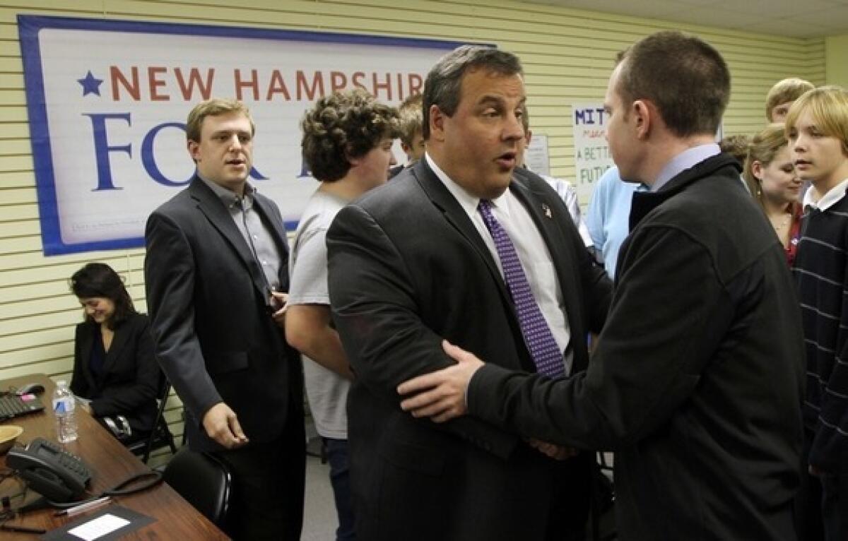 New Jersey Gov. Chris Christie shakes hands with volunteers at Mitt Romney's New Hampshire campaign headquarters Nov. 9 in Manchester.