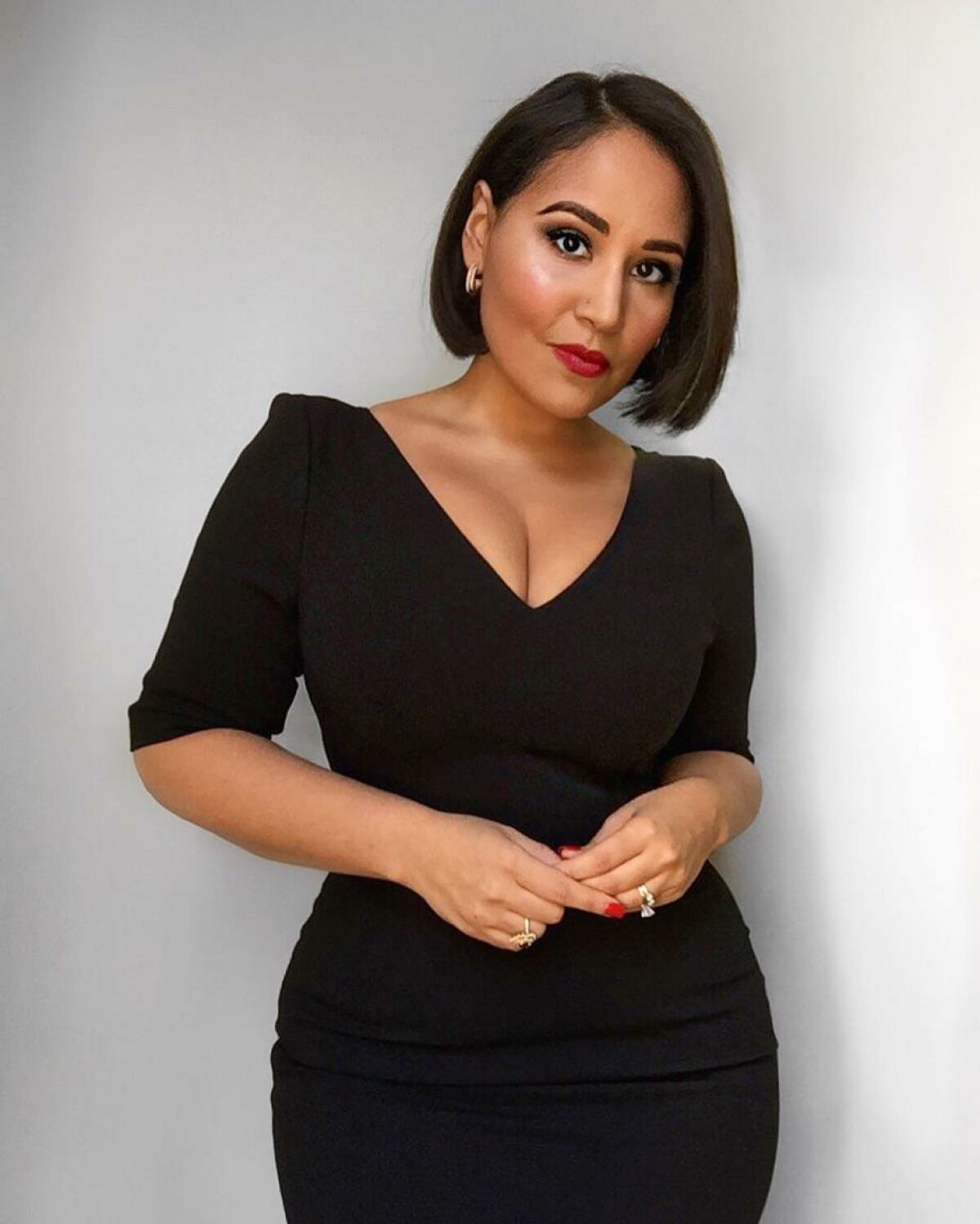 Chef and television personality Alejandra Ramos poses in front of a white wall.