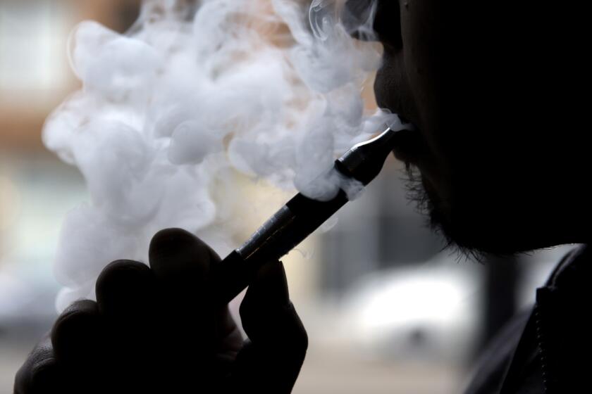 A man demonstrates an e-cigarette at a "vape" store in Chicago.