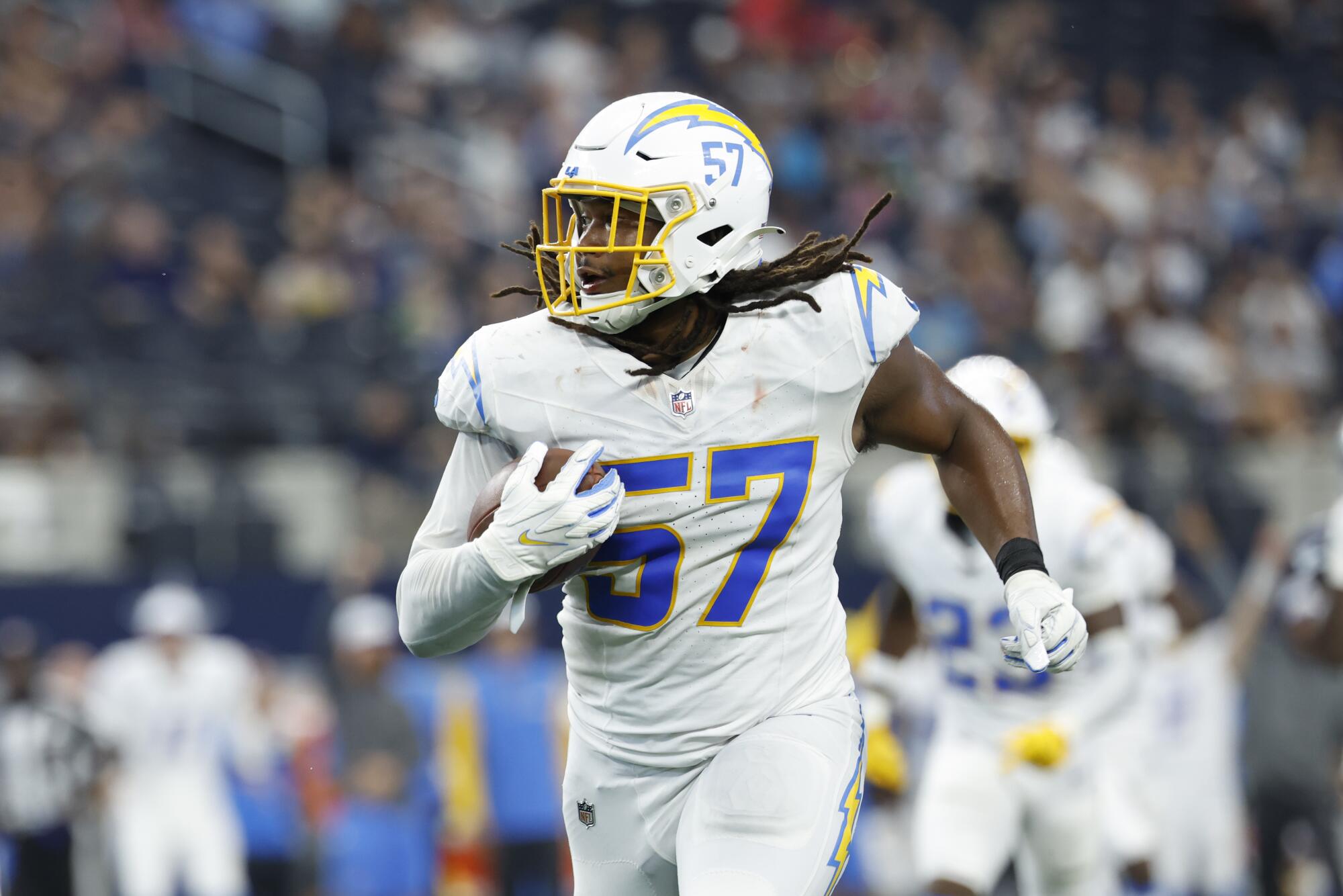 Chargers linebacker Tre'Mon Morris-Brash (57) returns an interception during a preseason game against the Cowboys.