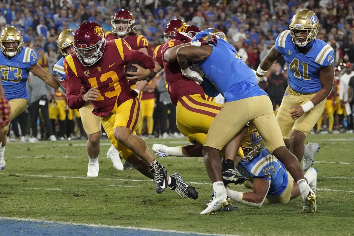 Caleb Williams scores a touchdown in USC's 48-45 win over UCLA on Nov. 19, 2022 at the Rose Bowl.