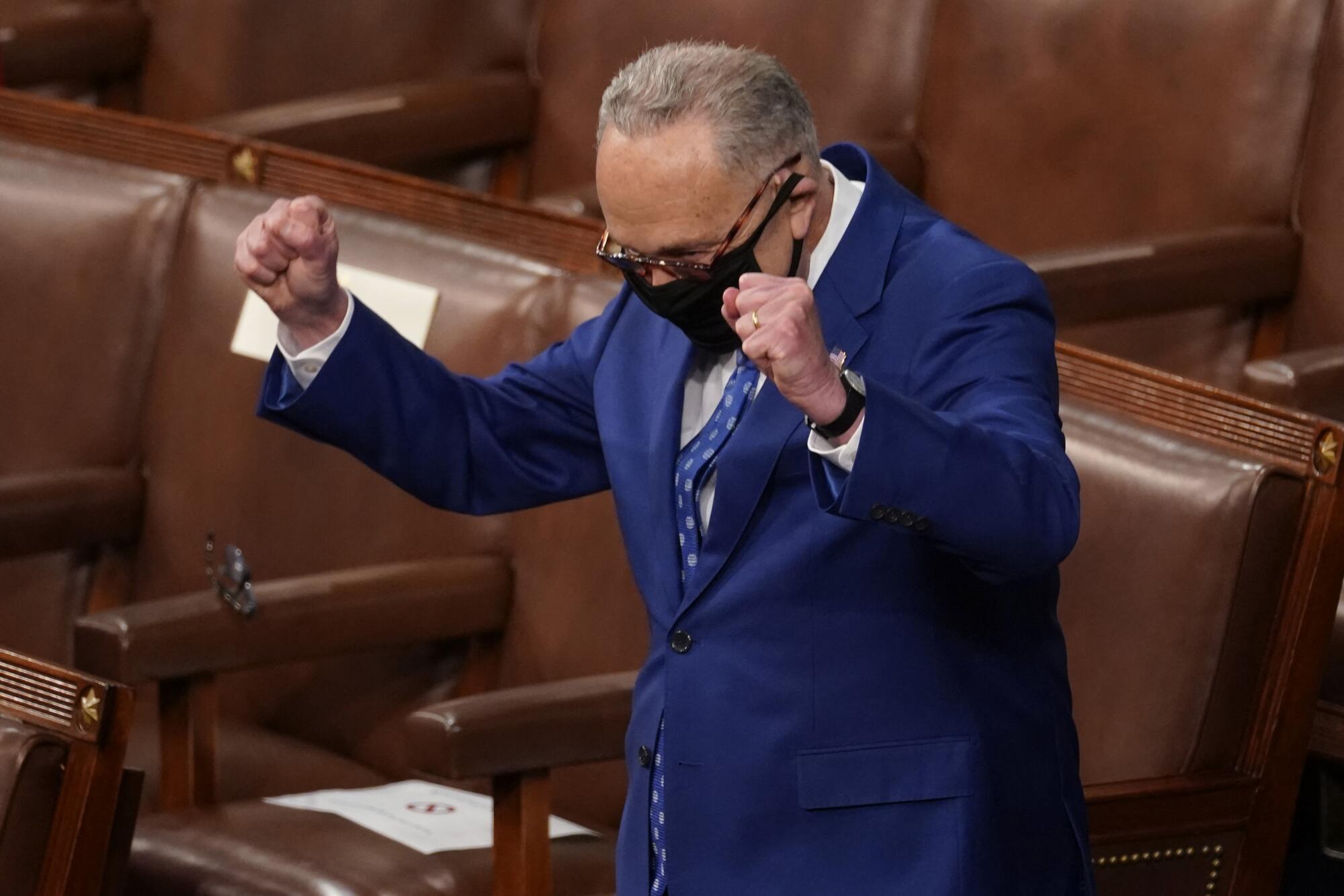 A man raises his arms.