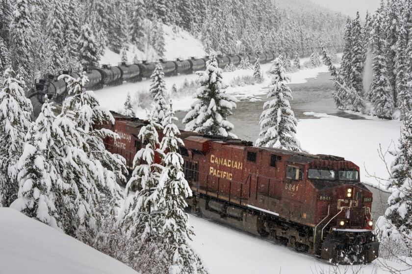 A Canadian Pacific train hauls oil westward through Banff National Park, Alberta, Canada, Sunday, Nov. 28, 2021. Refineries on the west coast of Canada have run short of crude oil following the shutdown of pipelines due to catastrophic flooding in southern British Columbia. (Frank Gunn/The Canadian Press via AP)