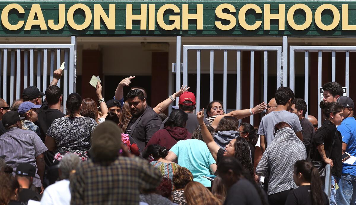 Parents wait to be reunited with their children at Cajon High School after a school shooting at North Park Elementary School.