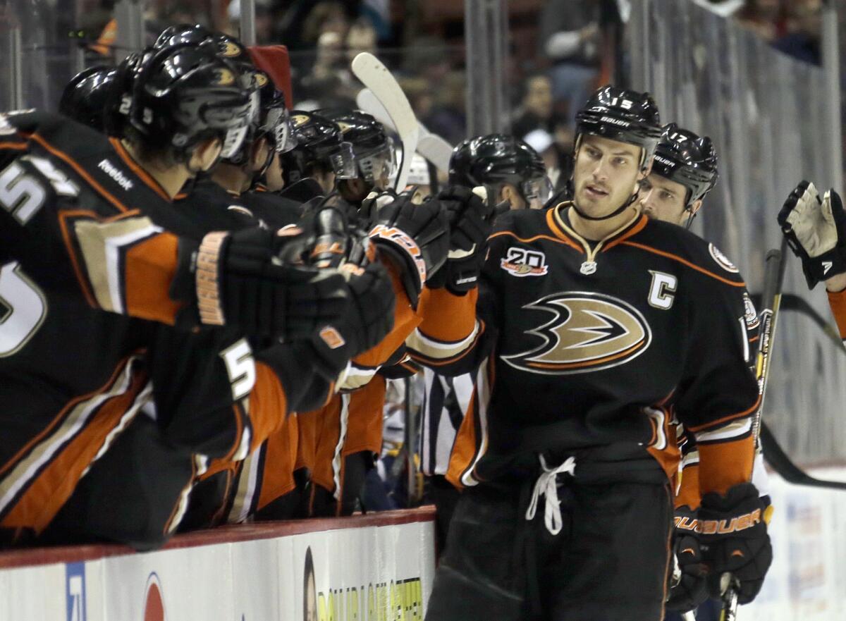 Ducks center Ryan Getzlaf is congratulated by teammates after the first of his three goals against Buffalo on Friday.