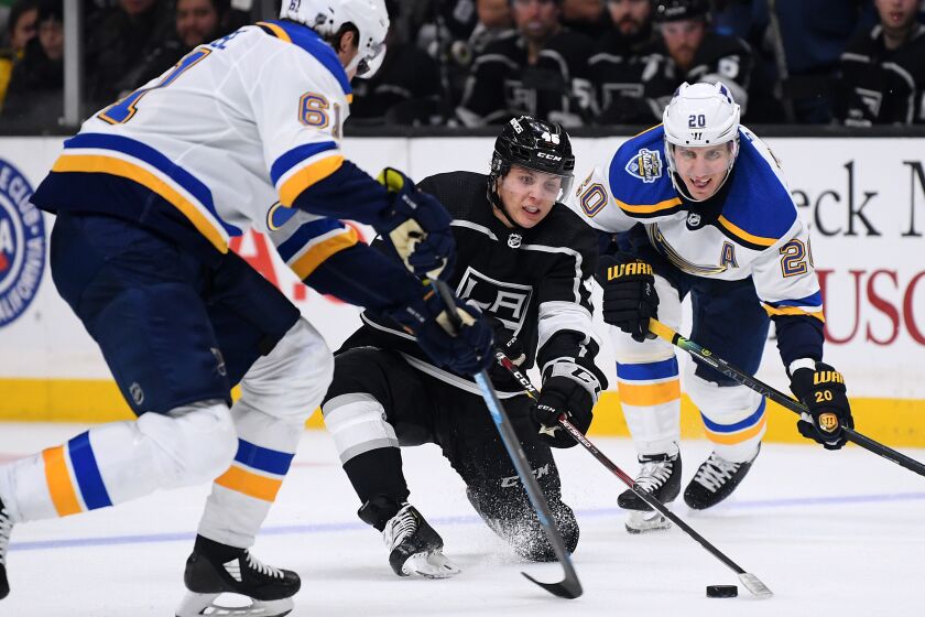 LOS ANGELES, CALIFORNIA - DECEMBER 23: Blake Lizotte #46 of the Los Angeles Kings stick handles between Jacob de la Rose #61 and Alexander Steen #20 of the St. Louis Blues during the second period at Staples Center on December 23, 2019 in Los Angeles, California. (Photo by Harry How/Getty Images)