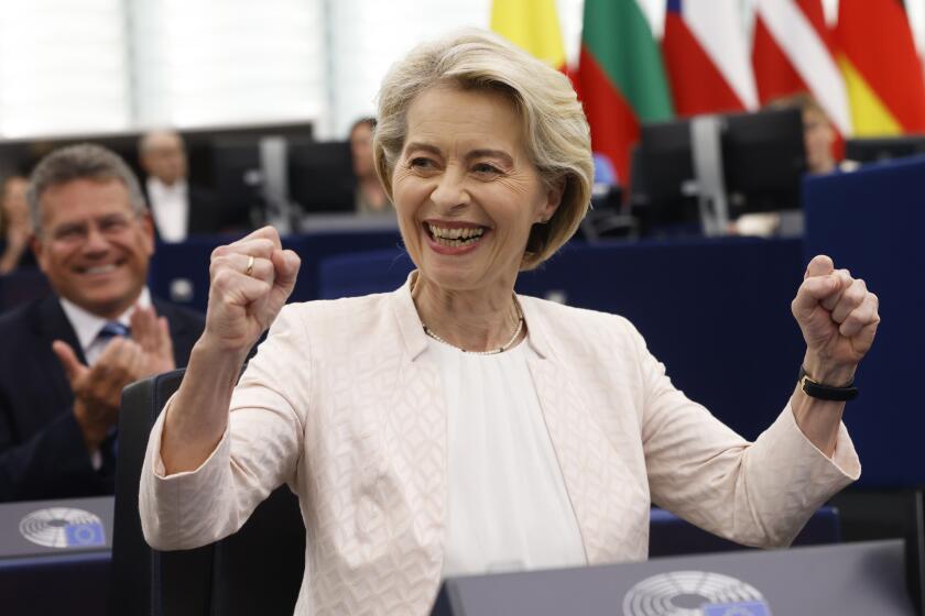 European Commission President Ursula von der Leyen, right, reacts after the announcement of the vote at the European Parliament in Strasbourg, eastern France, Thursday, July 18, 2024. Lawmakers at the European Parliament have re-elected Ursula von der Leyen to a second 5-year term as president of the European Union's executive commission. The re-election ensures leadership continuity for the 27-nation bloc as it wrestles with crises ranging from the war in Ukraine to climate change, migration and housing shortages. (AP Photo/Jean-Francois Badias)