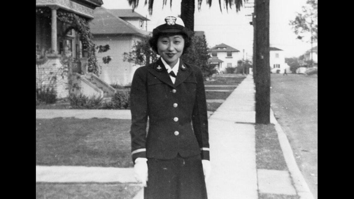 Susan Ahn Cuddy stands on the street where the Ahn family home was located between 1936 and 1946. Cuddy enlisted in the U.S. Navy in 1942. She is believed to be the first Asian American female U.S. Navy officer and became the Navy’s first female gunnery officer during World War II, according to her official 2002 biography.