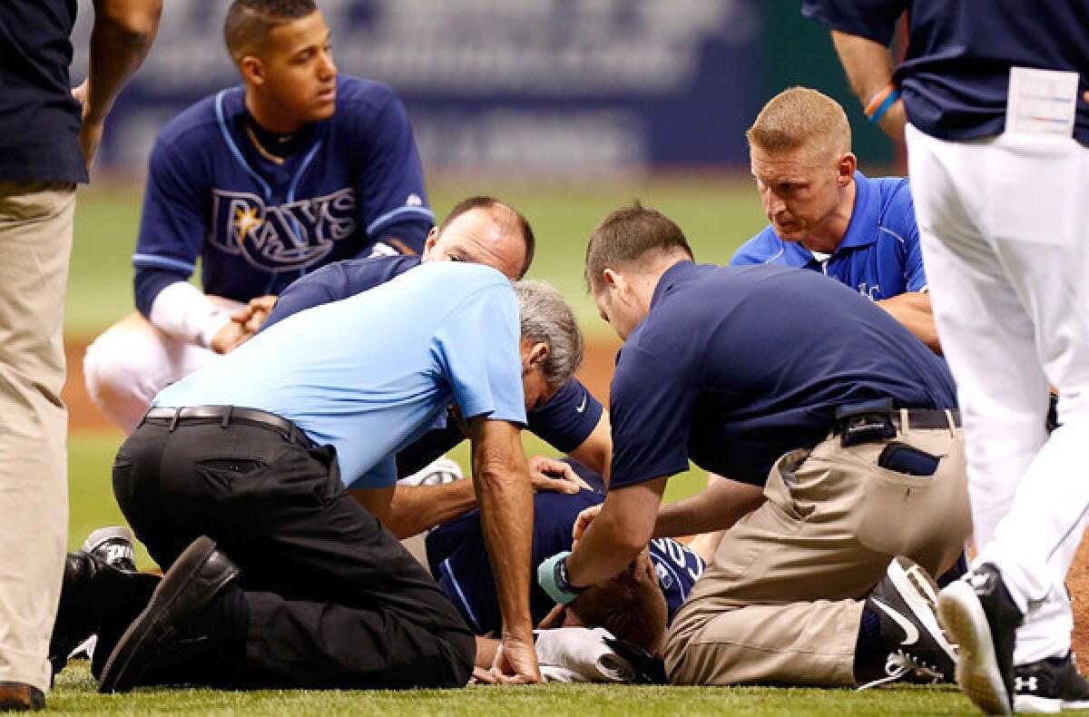 Medical staffers tend to Rays pitcher Alex Cobb after he was hit in the head by a line drive during a game against the Royals on Saturday.
