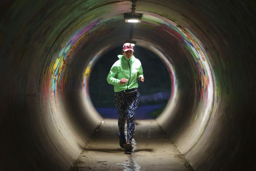 Ultra runner Helen Ryvar runs through an underpass in Wrexham during running a half marathon in Wrexham, Wales.
