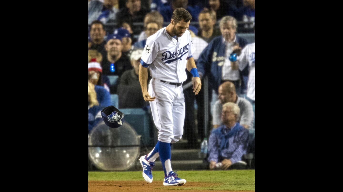 Dodgers center fielder Chris Taylor tosses his batting helmet after striking out in the third inning.
