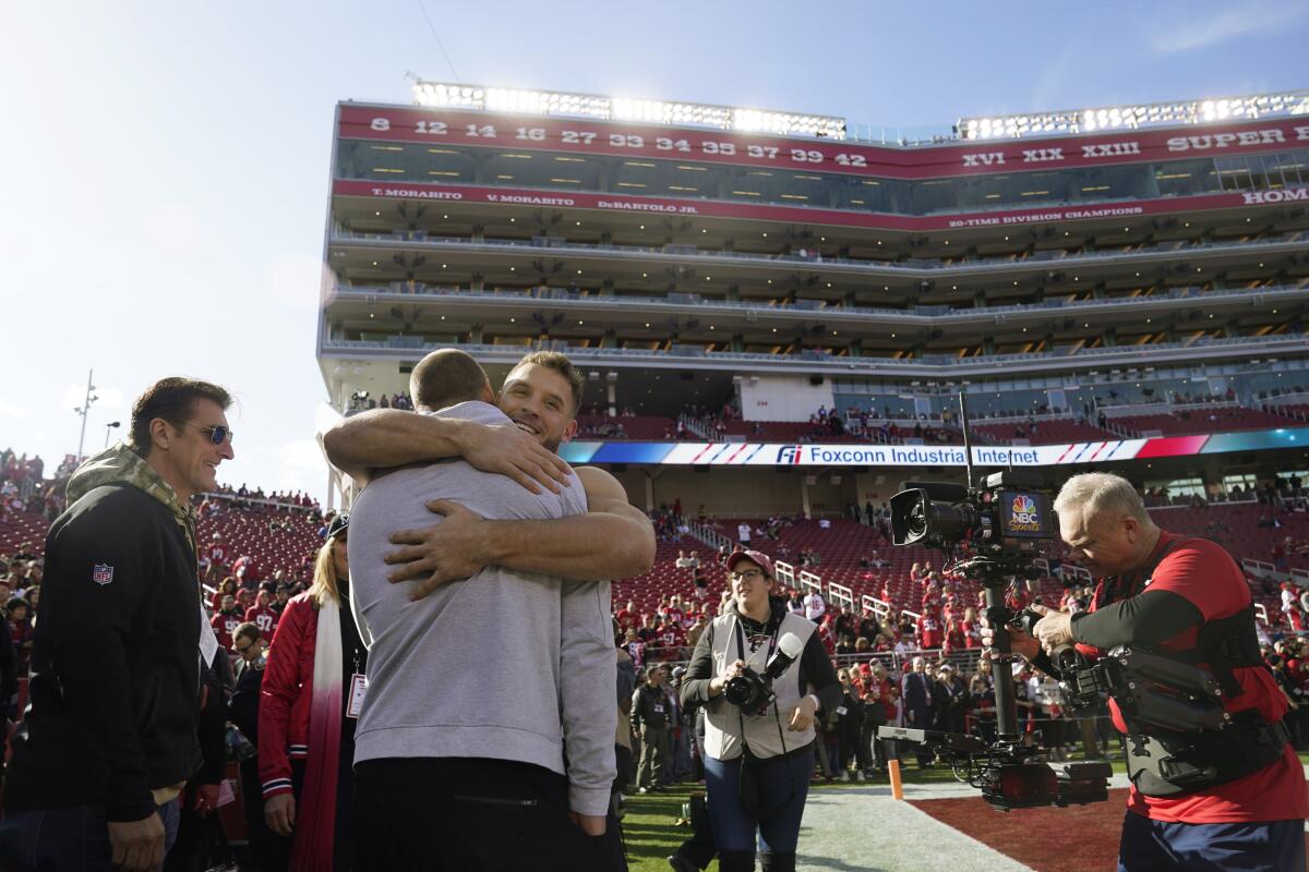 San Francisco 49ers rookie Nick Bosa hugs his brother, Chargers defensive end Joey Bosa, before a playoff game against the Minnesota Vikings.