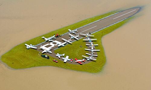 Small planes are clustered after being towed to the only remaining dry land at Bloomsburg Airport, as floodwaters from the Susquehanna River encroached on the airstrip Wednesday in Bloomsburg, Pa.