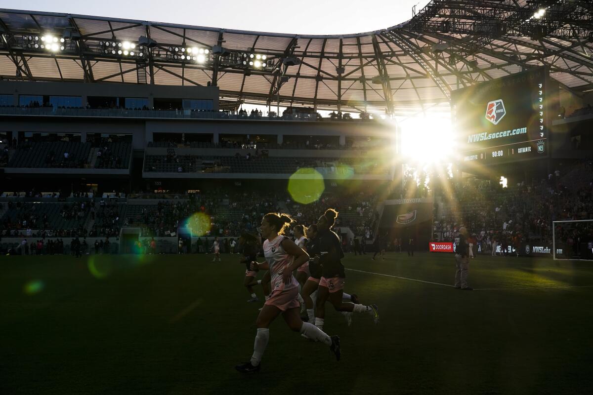 Angel City players run on the field after a match against NJ/NY Gotham FC on May 29, 2022.