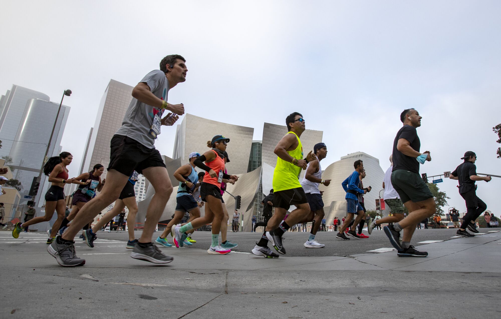 Runners turn onto Grand Avenue near Disney Concert Hall