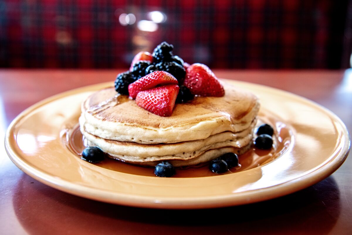 Pancakes served with berries on top