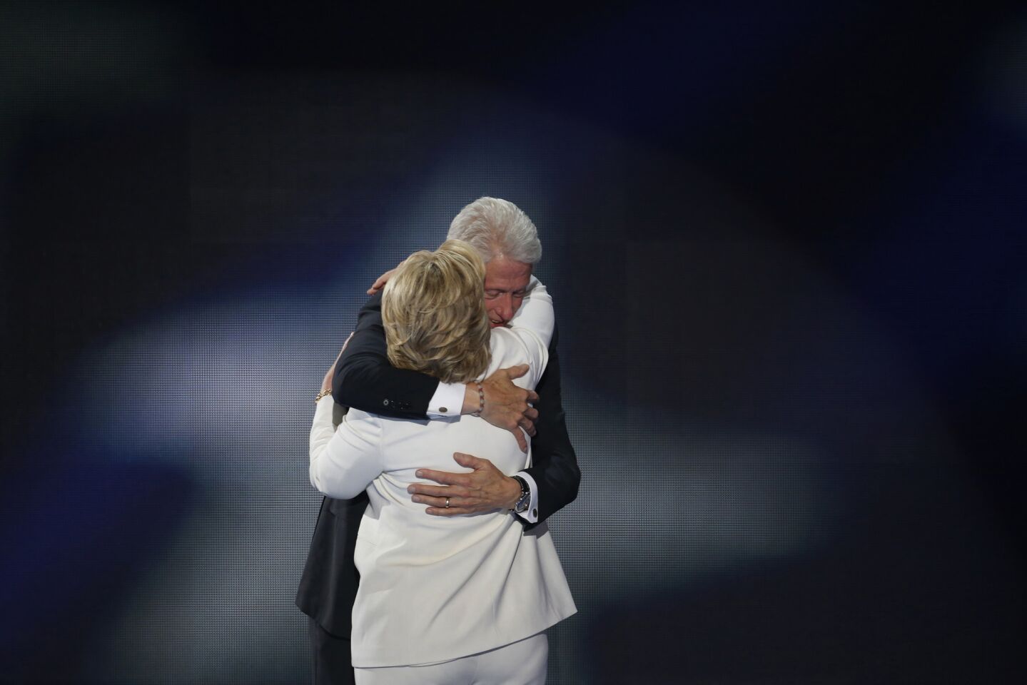 Hillary Clinton gets a hug from President Bill Clinton after becoming the first woman to win the nomination for President for any party in America.