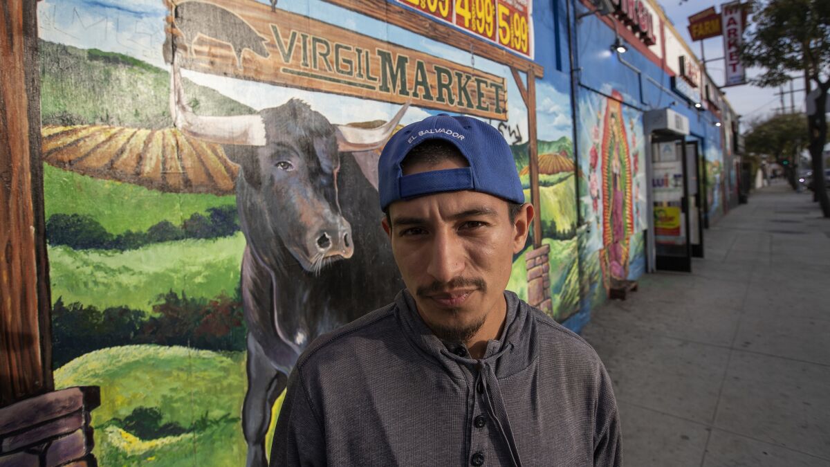 LOS ANGELES, CA-FEBRUARY 27, 2019: Jimmy Recinos, 28, is photographed outside of Virgil Farm Market, located on Virgil Ave. in Los Angeles, near his home, less than a block away. (Mel Melcon/Los Angeles Times)