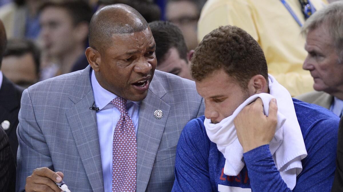 Clippers Coach Doc Rivers, left, speaks to Clippers power forward Blake Griffin during a loss to the Golden State Warriors on Nov. 5.