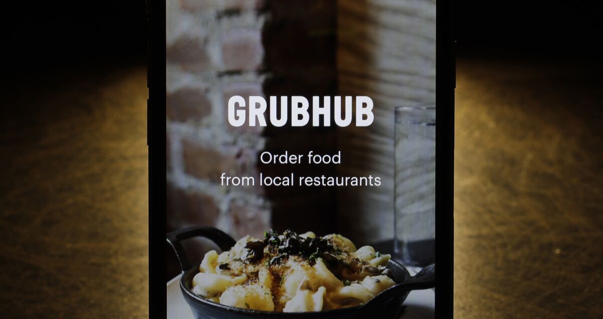 FILE - This Feb. 20, 2018, file photo shows the Grubhub app on an iPhone in Chicago. On Thursday, March 3, 2022, Grubhub said that it is ending its partnership with Russian tech company Yandex and pulling 100 Yandex-made food-delivery robots from the campuses of Ohio State University in Columbus, Ohio, and the University of Arizona in Tucson, Arizona. Chicago-based Grubhub said it is working with both campuses to find alternatives. (AP Photo/Charles Rex Arbogast, File)