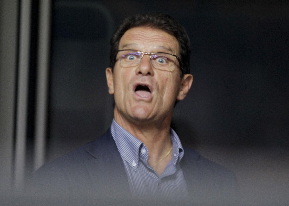England national soccer team coach Fabio Capello reacts as he sits in the stands prior to a Champions League, Group G soccer match between AC Milan and Auxerre at the San Siro stadium in Milan, Italy, Wednesday, Sept.15, 2010.