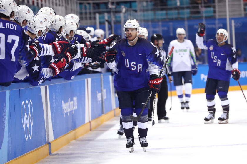 Brian O'Neill, center, celebrates after scoring against Slovenia in the 2018 Winter Olympics.