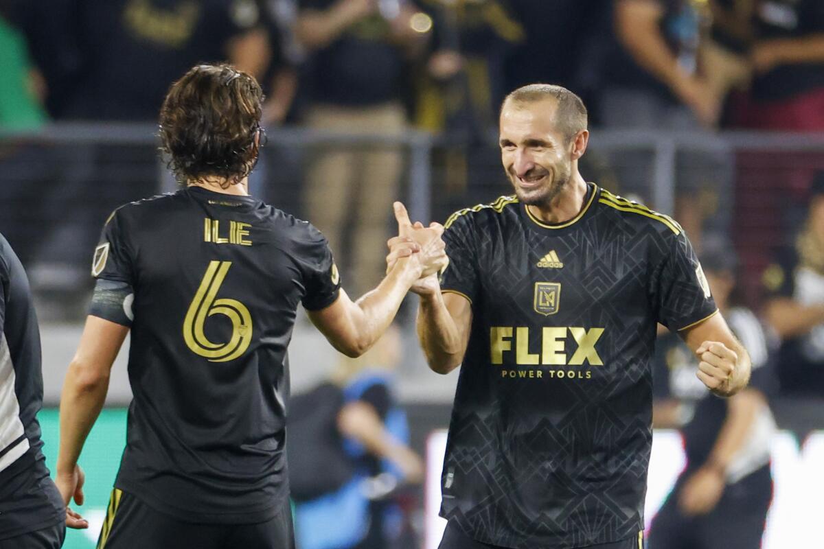 LAFC defender Giorgio Chiellini, right, celebrates with midfielder Ilie Sanchez after a playoff win over the Galaxy.