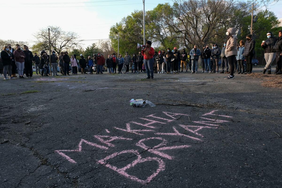 The name Ma'Khia Bryant written in chalk on blacktop at a vigil for the teenager. 
