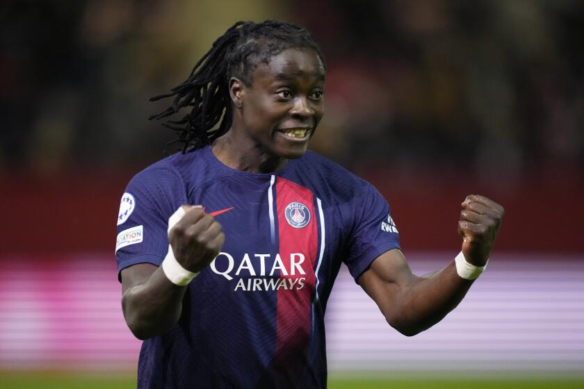FILE - PSG's Tabitha Chawinga celebrates after scoring during the women's Champions League group C soccer match between FC Bayern Munich and Paris Saint-Germain in Munich, Germany, on Jan. 30, 2024. Paris Saint-Germain forward Tabitha Chawinga faced challenges as a young soccer player growing up in Malawi. Her parents disapproved and wanted her to stop playing. (AP Photo/Matthias Schrader, File)