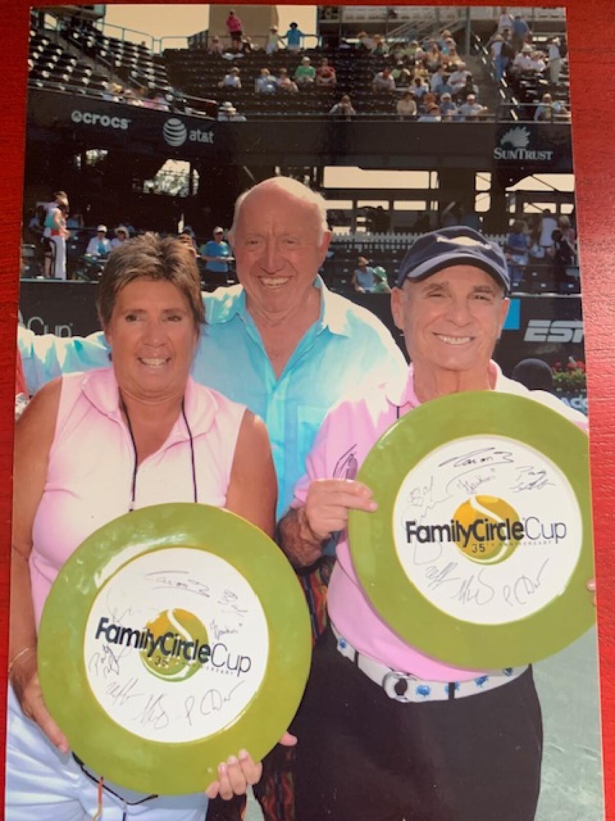 Jack Jones, right, stands with tennis legend Rosie Casals, left, and tennis broadcaster Bud Collins.