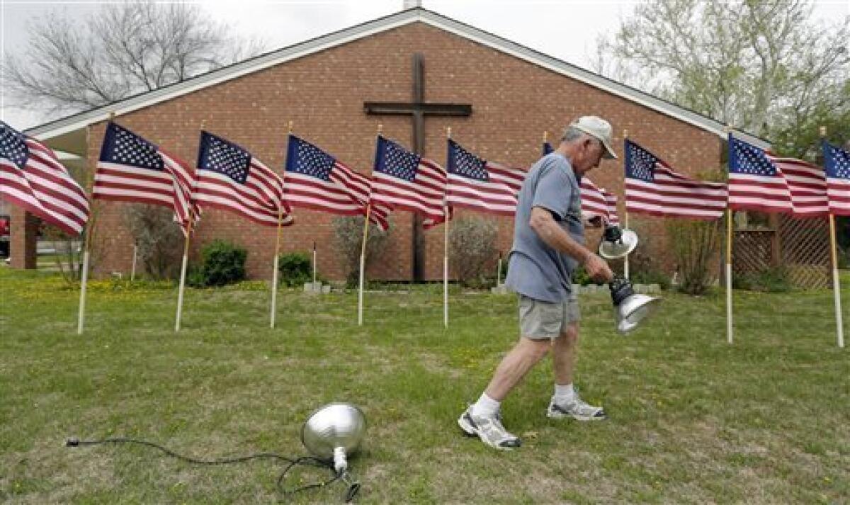 Bob Gordon works on a memorial at Central Christian Church in Killeen, Texas, for the victims the recent shooting at Ft. Hood.