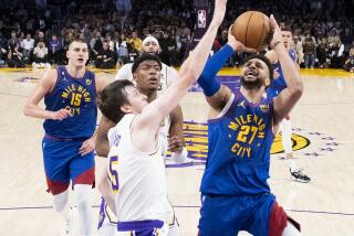 LOS ANGELES, CA - MAY 20: Denver Nuggets guard Jamal Murray, right, shoots while Los Angeles Lakers guard Austin Reaves defends during the second quarter of game three in the NBA Playoffs Western Conference Finals at Crypto.com Arena on Saturday, May 20, 2023 in Los Angeles, CA. (Gina Ferazzi / Los Angeles Times)