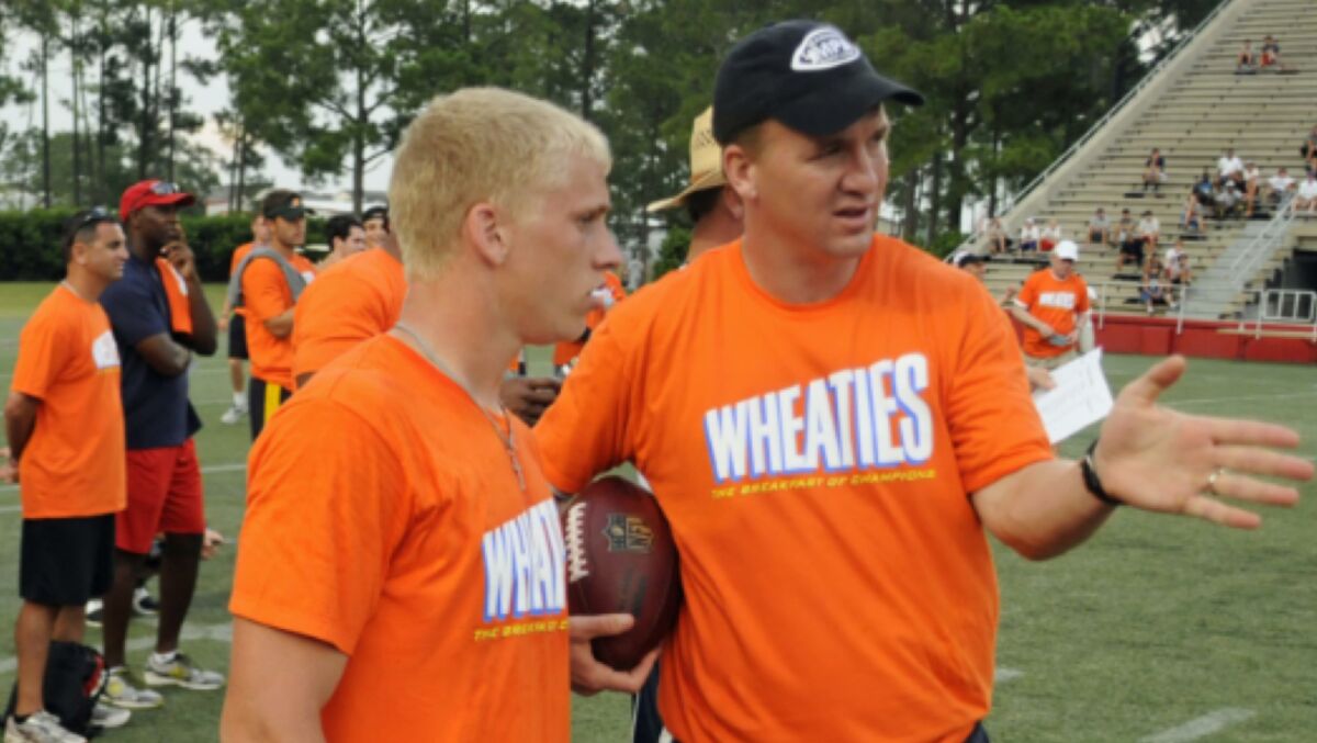 Peyton Manning gives instructions to Cooper Kupp at the Manning Passing Academy, where Kupp participated for five years as a camper then a counselor.