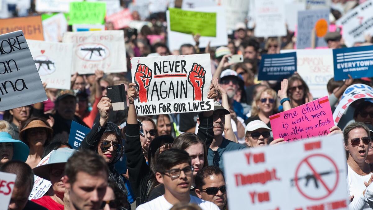 Demonstrators call for gun reform during the March for Our Lives OC at Centennial Park in Santa Ana on March 24.