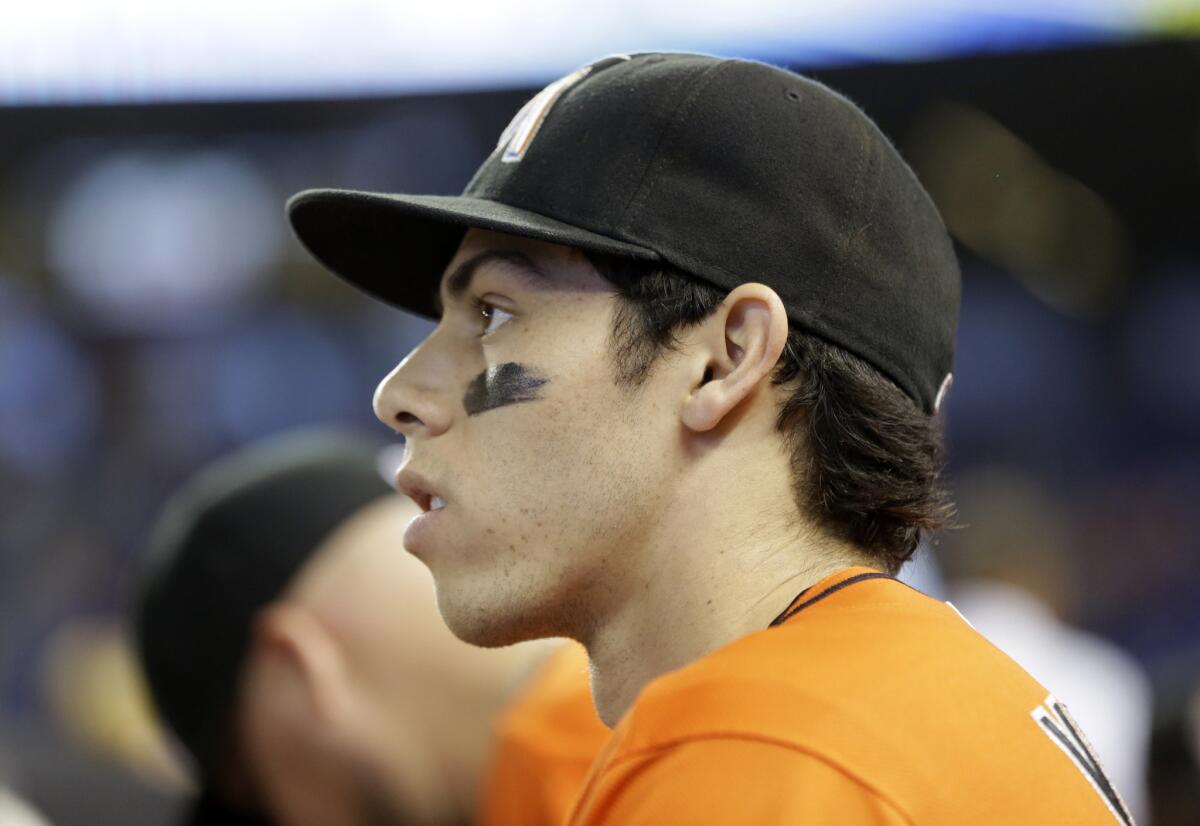 Miami Marlins left fielder Christian Yelich looks out from the dugout before a game against the Cincinnati Reds on July 12.