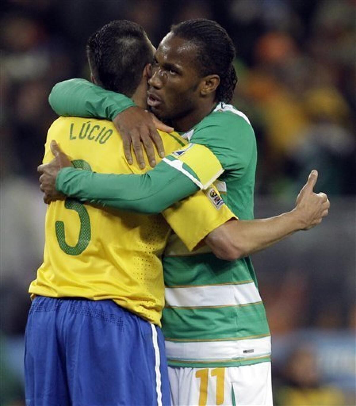 Ivory Coast's Didier Drogba, right, hugs Brazil's Lucio after the World Cup group G soccer match between Brazil and Ivory Coast at Soccer City in Johannesburg, South Africa, Sunday, June 20, 2010. Brazil won 3-1. (AP Photo/Yves Logghe)