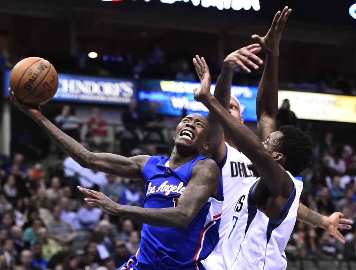 Jamal Crawford drives to the basket against Dallas Mavericks forwards Charlie Villanueva and Al-Farouq Aminu during the second half of a game on Feb. 9.