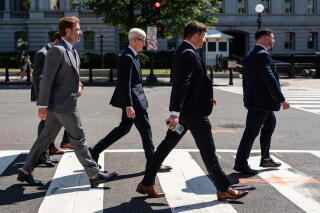 Tim Cook walking in a crosswalk with others