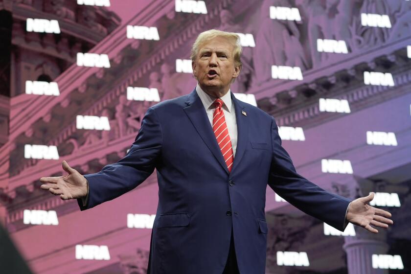 Former President Donald Trump gestures as he is applauded before speaking at the National Rifle Association Convention, Saturday, May 18, 2024, in Dallas. (AP Photo/LM Otero)