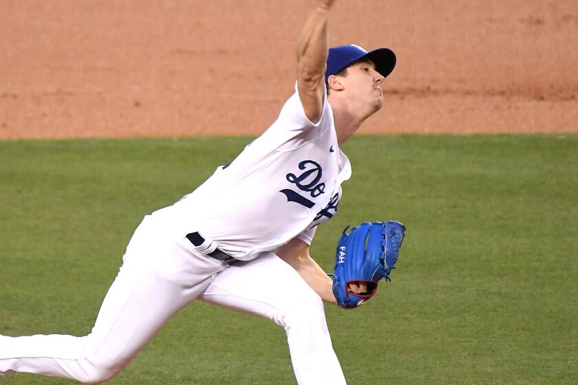 Los Angeles Dodgers' Dustin May takes liner off head during game