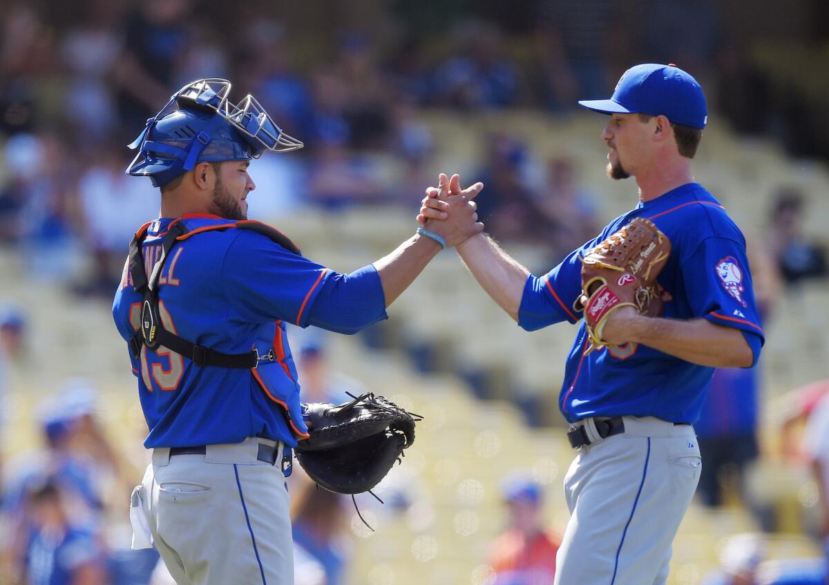 Catcher Johnny Monell and relief pitcher Logan Verrett celebrate the Mets' 8-0 victory over the Dodgers.