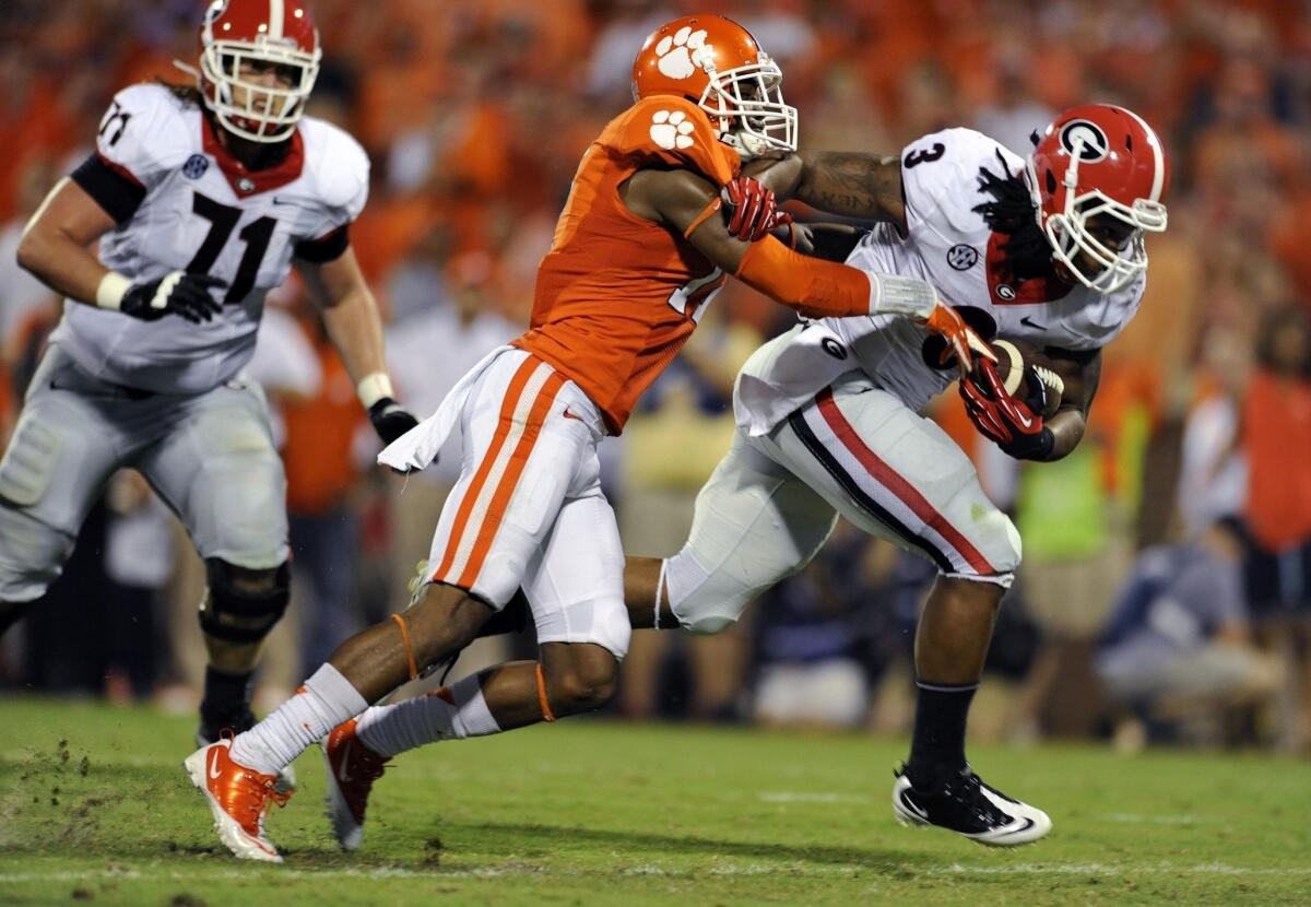 Georgia running back Todd Gurley, right, breaks a tackle by Clemson's Bashuad Breeland during the Bulldogs' loss Saturday. Georgia could find some redemption in the rankings with a win over South Carolina this week.