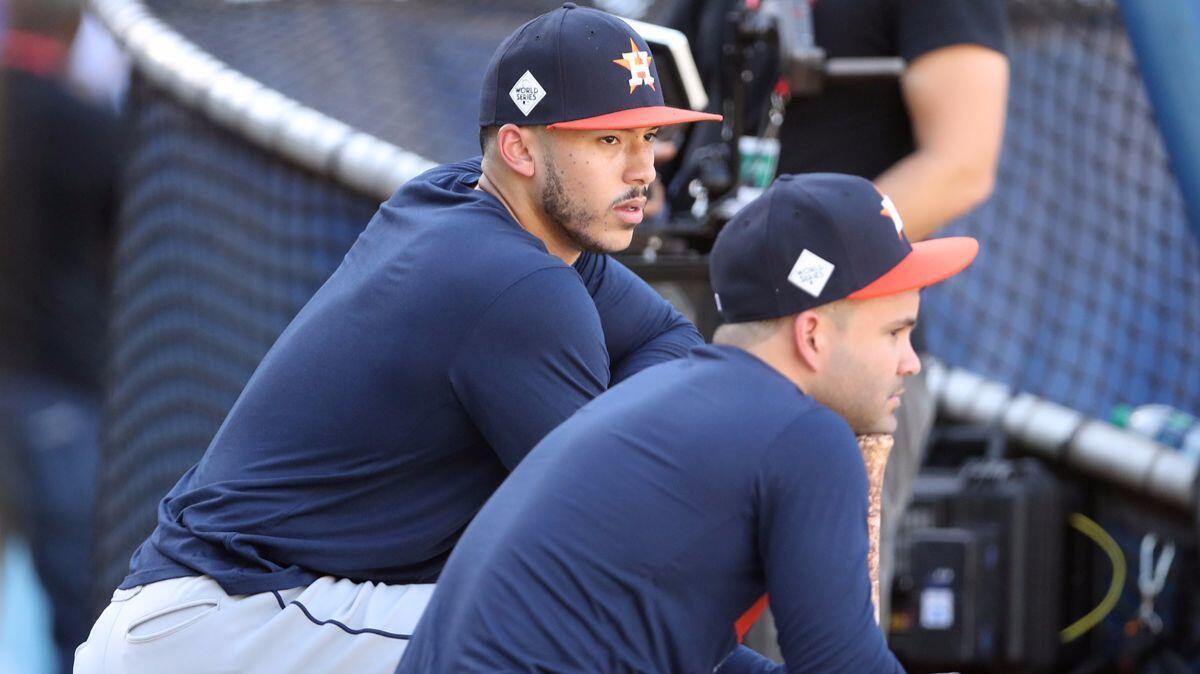 Houston Astros shortstop Carlos Correa, left, talks with second baseman Jose Altuve during batting practice prior to Game 1 of the 2017 World Series against the Dodgers.