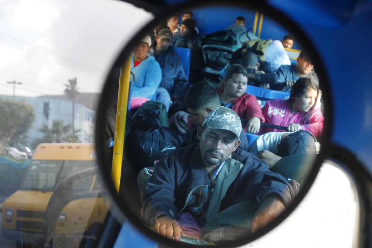 TIJUANA, November 30, 2018 | Central American migrants, who were staying at the Benito Juarez sports complex shelter, are reflected in a mirror as they ride a bus to the newly set up El Barretal shelter eleven miles away in Tijuana on Friday. | Photo by Hayne Palmour IV/San Diego Union-Tribune/Mandatory Credit: HAYNE PALMOUR IV/SAN DIEGO UNION-TRIBUNE/ZUMA PRESS San Diego Union-Tribune Photo by Hayne Palmour IV copyright 2018