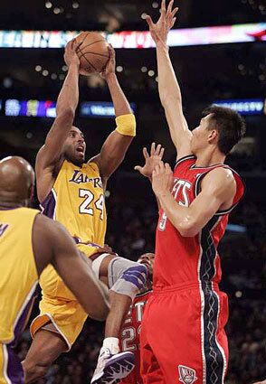 Lakers Kobe Bryant drives to the basket against Yi Jianlian of the New Jersey Nets in the third quarter Tuesday night.