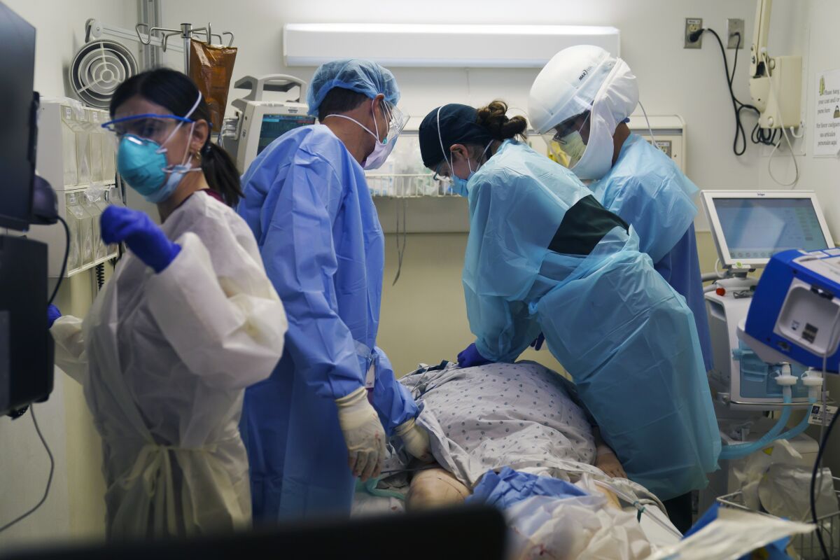 Medical professionals work to revive a COVID-19 patient at Providence Holy Cross Medical Center in L.A.'s Mission Hills.