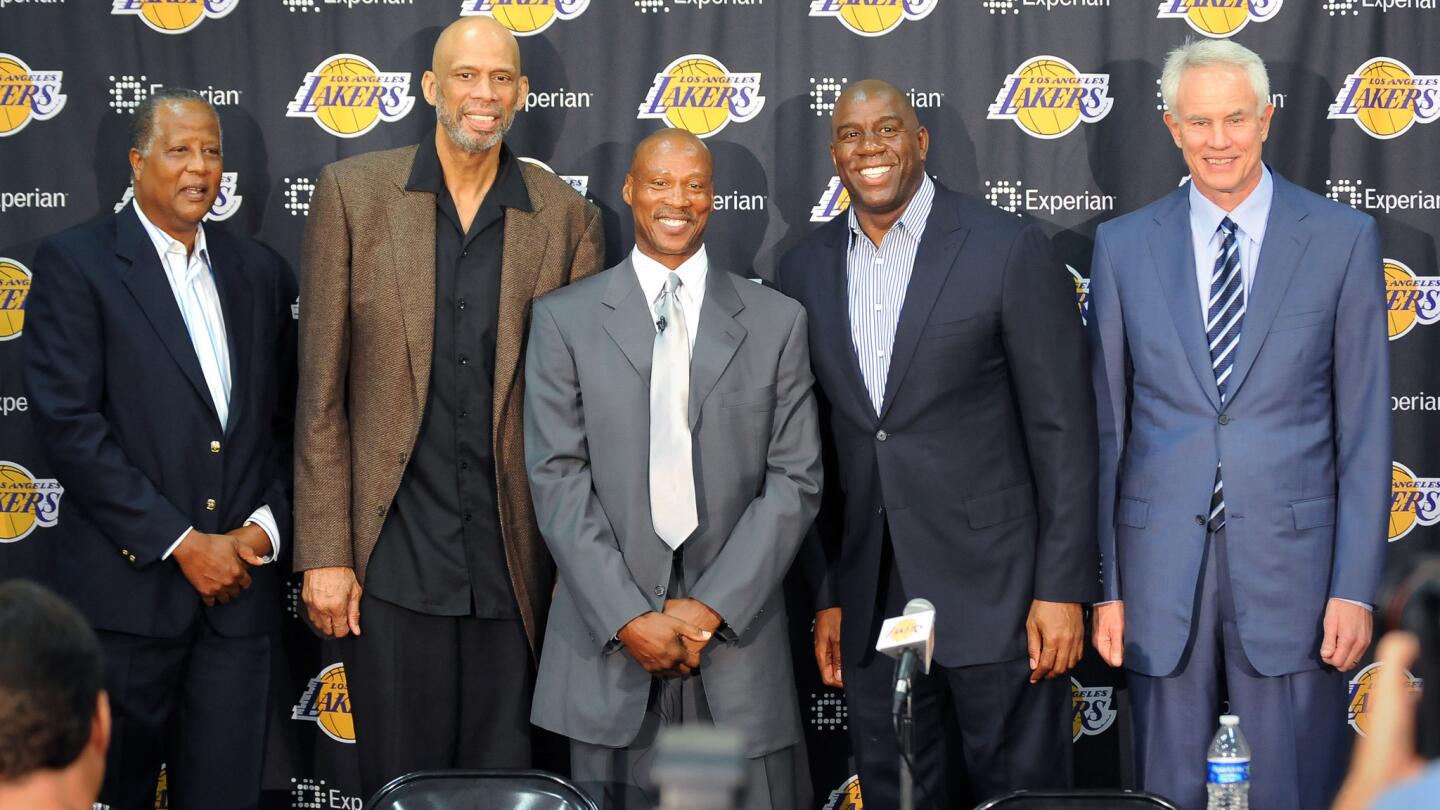 Lakers Coach Byron Scott, center, poses during a news conference with former Lakers teammates (from left) Jamal Wilkes, Kareem Abdul-Jabbar, Magic Johnson and general manager Mitch Kupchak on July 29, 2014.