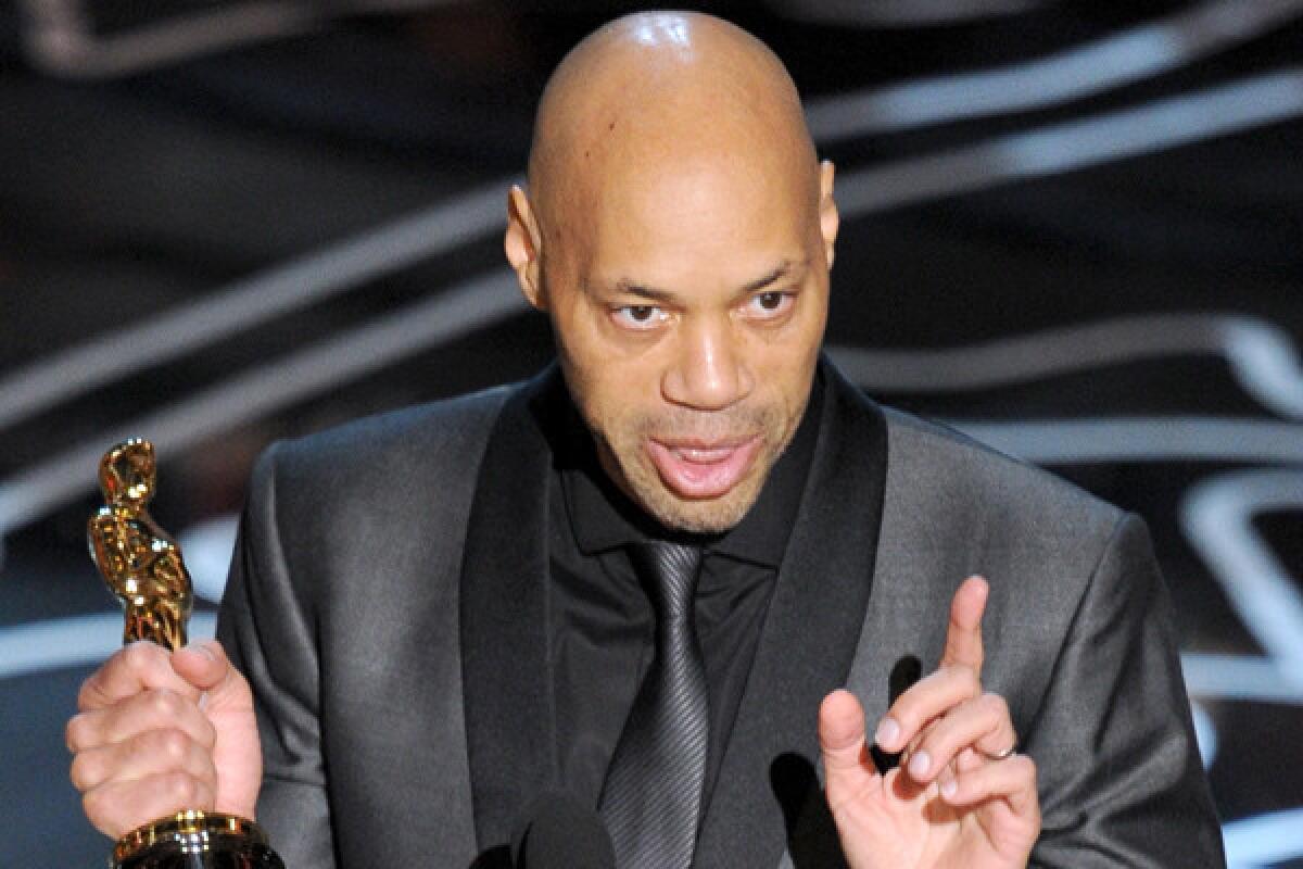 Screenwriter John Ridley accepts the Oscar for adapted screenplay for "12 Years a Slave."