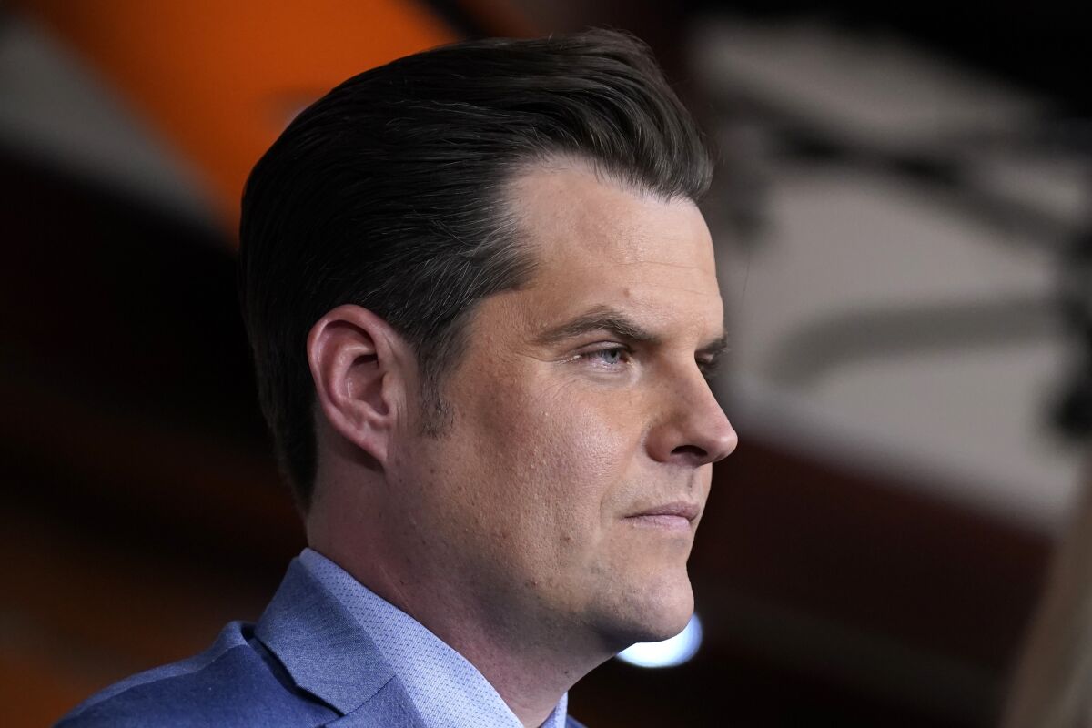 FILE - Rep. Matt Gaetz, R-Fla., listens during a news conference at the Capitol in Washington, Tuesday, Dec. 7, 2021. A former employee in the office of a Florida tax collector whose arrest triggered an investigation into U.S. Rep. Gaetz has pleaded guilty to fraud and drug charges. Court documents showed that Joseph Ellicott pleaded guilty on Monday, Jan. 24, 2022. (AP Photo/J. Scott Applewhite, File)